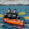 Group enjoying a peaceful kayaking experience with crystal-clear waters surrounding Bergen.