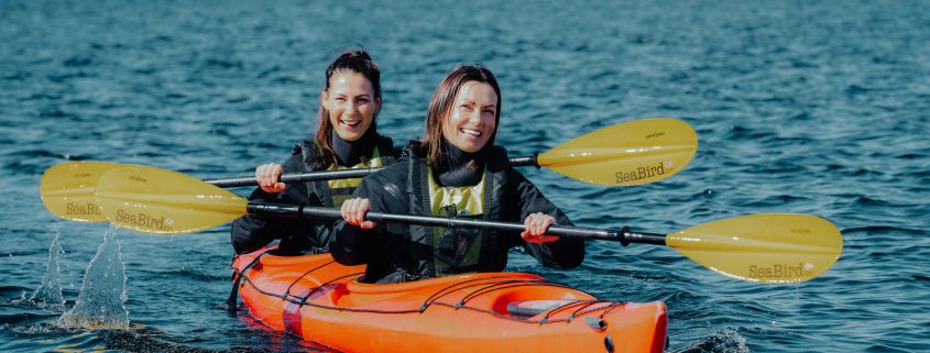 Group enjoying a peaceful kayaking experience with crystal-clear waters surrounding Bergen.